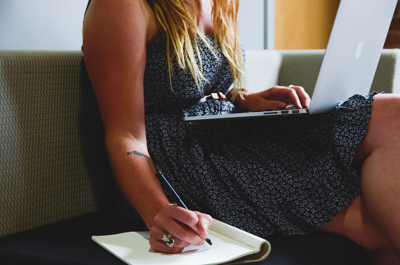 Woman planning with a laptop on the couch