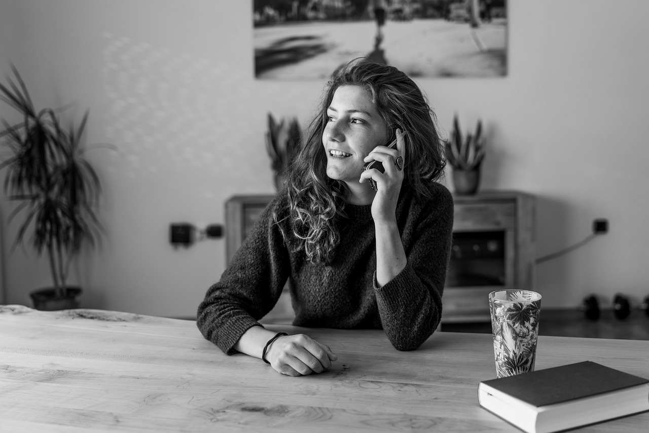 Woman talking with a phone at home